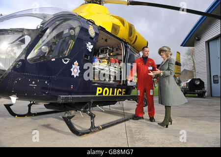 The Duchess of Cornwall chats with team leader Richard Miller as they look at the McDonnell Douglas 902 Explorer helicopter, belonging to the Wiltshire Air Ambulance service, Devizes Wiltshire, where she is being shown the equipment used on the helicopter and the day to day workings of the Flight Operations Room. Stock Photo