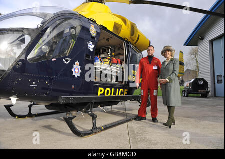 The Duchess of Cornwall chats with team leader Richard Miller as they look at the McDonnell Douglas 902 Explorer helicopter, belonging to the Wiltshire Air Ambulance service, Devizes Wiltshire, where she is being shown the equipment used on the helicopter and the day to day workings of the Flight Operations Room. Stock Photo