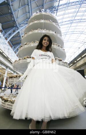 Television personality and former Blue Peter presenter, Konnie Huq, unveils a 3.5 metre tall cake tower filled with 3,000 cakes for the Kenwood Make-A-Wish Foundation's successful Guinness World Record attempt for the World's Largest Cupcake Tower at St Pancras station, London. Stock Photo