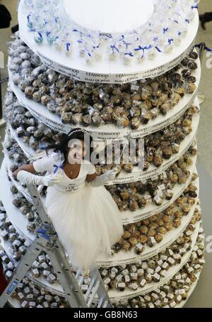 Television personality and former Blue Peter presenter, Konnie Huq, unveils a 3.5 metre tall cake tower filled with 3,000 cakes for the Kenwood Make-A-Wish Foundation's successful Guinness World Record attempt for the World's Largest Cupcake Tower at St Pancras station, London. Stock Photo