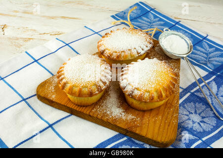 Small confiture pies and baking sieve. Jam pie. Small pie. Pie. Sweet pastry. Sweet dessert Stock Photo