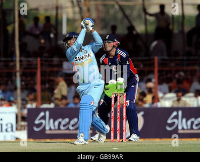 India's Virender Sehwag hits a six of England's Paul Collingwood's first ball during The First One Day International at Madhavrao Scindia Cricket Ground, Rajkot, India. Stock Photo