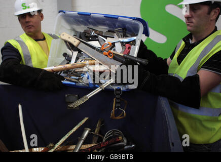 Workers in Broxburn collects for shredding some of the 3,000 knives seized or handed in during the first five months of Strathclyde Police's Campaign Against Violence. Stock Photo