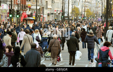 A huge crowd of Christmas shoppers block the pavements and the road, as Oxford Street is pedestrianised to help with the large crowds. Stock Photo