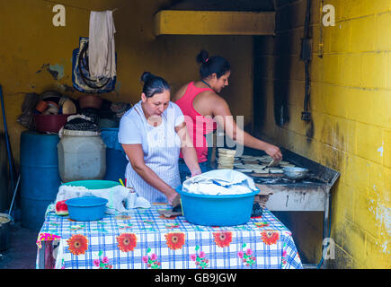 Salvadoran women prepare Popusas in Suchitoto El Salvador Stock Photo