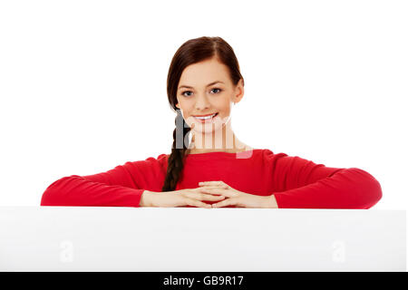 Beautiful young woman holding a blank banner Stock Photo