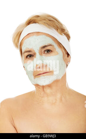 Relaxed elderly woman in facial mask Stock Photo