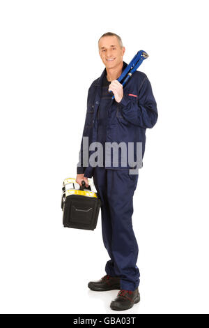 Mature worker with tools bag and wrench Stock Photo