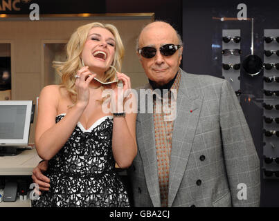 Singer Katherine Jenkins (Left) and Mohamed Al Fayed try on sunglasses during the launch of the Winter Sale at Harrods department store, Knightsbridge, west London. Stock Photo