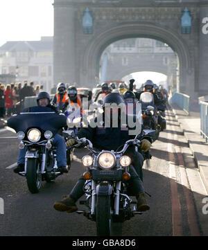 Bikers from the Ace Cafe in north London ride over Tower Bridge during a motorbike convoy through central London to celebrate the launch of the movie HellBoy 2: The Golden Army on DVD and Blu-Ray and also to raise money for the road safety charity BRAKE. Stock Photo