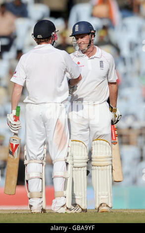 England's Paul Collingwood congratulates Andrew Strauss on scoring his half century during the third day of the First Test Match at the M. A. Chidambaram Stadium in Chennai, India. Stock Photo