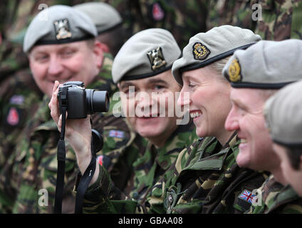 Captain Olivia Berry, third right, from The Royal Scots Dragoon Guards, takes a self portrait, whilst waiting for the official regimental photograph to be taken, after their return from their deployment to Afghanistan at Wessex Barracks in Bad Fallingbostel, Germany. Stock Photo