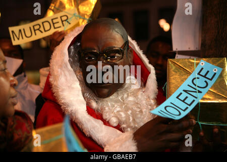 A protester dressed in a Santa Claus suit and wearing a Robert Mugabe mask outside Zimbabwe's embassy in London where demonstrators demanded action to oust Mr Mugabe from power in the country, which is in the grip of a major cholera outbreak and near economic collapse. Stock Photo