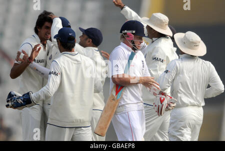 England's Ian Bell (centre) leaves the field after being bowled out by India's Ishant Sharma for 1 during the third day of the second test at the Punjab Cricket Association Stadium, Mohali, India. Stock Photo