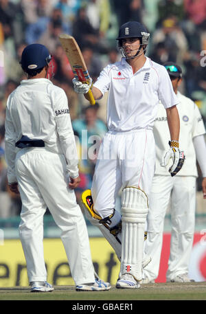 England's Alastair Cook celebrates scoring a half century during the third day of the second test at the Punjab Cricket Association Stadium, Mohali, India. Stock Photo