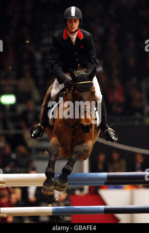 Ben Maher from Great Britain riding Robin Hood W comes second in the Olympia Grand Prixduring the London International Horse Show at Olympia, London. Stock Photo