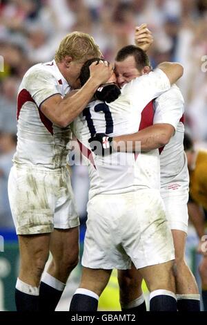 England's Jason Leonard (c) celebrates at the final whistle with teammates Lewis Moody (l) and Steve Thompson (r) Stock Photo