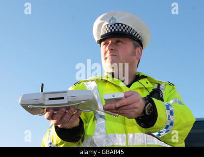 Lothian and Borders police officer Tom Boyle demonstrates using Bluetooth message equipment during the launch of the police campaign against drink driving this Christmas, in Edinburgh. Stock Photo