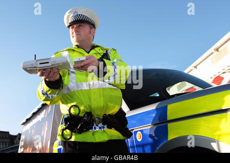 Lothian and Borders police officer Tom Boyle demonstrates using Bluetooth message equipment during the launch of the police campaign against drink driving this Christmas, in Edinburgh. Stock Photo