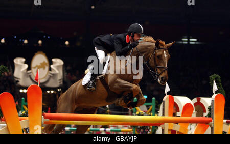 Ben Maher from Great Britain riding Ornike competes in the KBIS Christmas Pudding Speed Stakes on the third day of Olympia The London International Horse Show being held at the Olympia Exhibition Centre in West London. Stock Photo