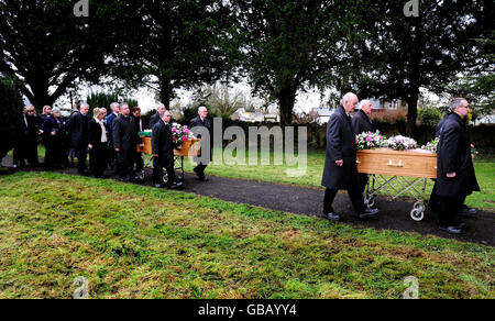 Coffins carrying the bodies of businessman Christopher Foster's wife Jill and daughter Kirstie are taken into church for funerals at St John's Church, Maesbrook, Shropshire. Stock Photo