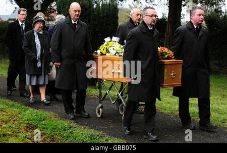 Family members follow the coffin as they arrive for the funeral of businessman Christopher Foster at St John's Church, Maesbrook, Shropshire. Stock Photo