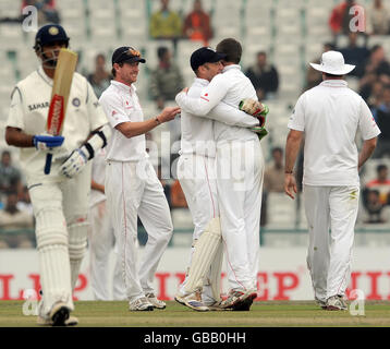 England's Graeme Swann is congratulated after Alastair Cook caught Gautam Gambhir for 179 during the second day of the second test at the Punjab Cricket Association Stadium, Mohali, India. Stock Photo