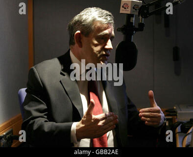 Prime Minister Gordon Brown gives a radio interview during his visit to open the Headquarters of Global Radio in Leicester Square, central London. Stock Photo