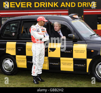 Current Formula 1 World Champion Lewis Hamilton (left) joins Mayor of London Boris Johnson in backing an anti-drink-drive campaign at Potters Fields Park in London. Stock Photo