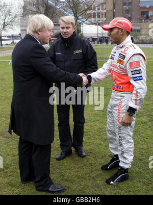 Retired Formula 1 World Champion Mika Hakkinen (centre) and current Formula 1 World Champion Lewis Hamilton (right) join Mayor of London Boris Johnson in backing an anti-drink-drive campaign at Potters Fields Park in London. Stock Photo