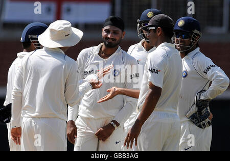 India's Harbhijan Singh is congratulated after England's Graeme Swann is caught behind for 1 during the second day of the First Test Match at the M. A. Chidambaram Stadium in Chennai, India. Stock Photo