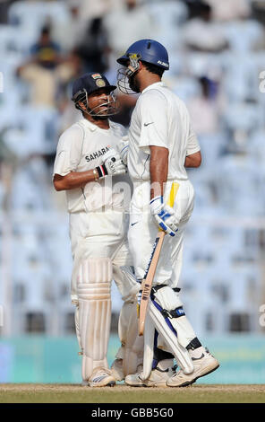 India's Yuvraj Singh and Sachin Tendulkar celebrate a partnership of 100 during the fifth day of the First Test Match at the M. A. Chidambaram Stadium in Chennai, India. Stock Photo