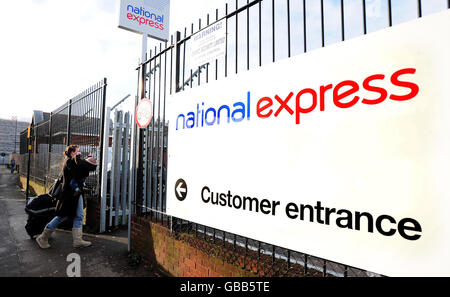 Passengers arrive at a National Express bus Depot in Digbeth, Birmingham. The Train and bus operator said today that it planned to cut up to 750 jobs in a bid to save 15 million a year. Stock Photo