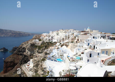 The romantic and unique village of Oia on the Greek island of Santorini. Small cave like dwellings overlooking the Mediterranean Stock Photo