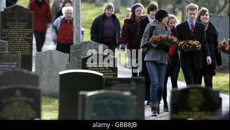 Members of the congregation attend a wreath laying ceremony at the Garden of Remembrance in Tundergarth to mark the 20th anniversary of the Lockerbie air disaster. Stock Photo