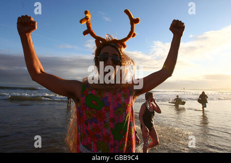 A swimmer in the sea at the Aberdeen Lions Club Nippy Dipper Boxing Day dip into the North Sea at Aberdeen Beach. Stock Photo