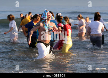 Swimmers in the sea at the Aberdeen Lions Club Nippy Dipper Boxing Day dip into the North Sea at Aberdeen Beach. Stock Photo