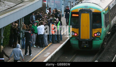 A train passes as friends gather to mourn Sam Griffiths, 16, from west London, at the scene where he died in the early hours of New Years Day after being electrocuted on railway lines at Burgess Hill station, West Sussex. Stock Photo