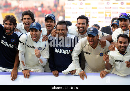 Indian players celebrate after winning the test series 1-0 following the close of play on the fifth day of the second test at the Punjab Cricket Association Stadium, Mohali, India. Stock Photo