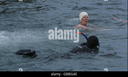 Christmas day swim - Ireland. Swimmers in the sea at Forty Foot during the annual Christmas Day swim near Sandycove, Dublin. Stock Photo