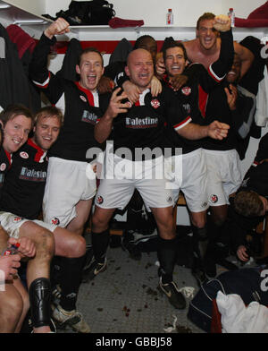 Kettering Town captain Guy Branston (centre) leads the celebrations with Gareth Seddon (right) and Darren Wrack (left) following the FA Cup Third Round match at Rockingham Road, Kettering. Stock Photo