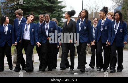 Georgetta Holloway (centre in dark suit) Associate Headteacher of Heath Park Business and Enterprise College, Wolverhampton, walks with pupils as the college has been named England's most improved school, according to league tables. Stock Photo