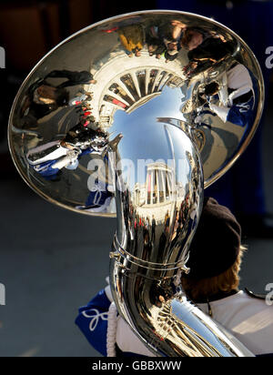 The National Gallery is seen reflected in the instruments of the Prospect High School Marching Knights, a marching band from Illinois, United States of America as they perform in Trafalgar Square, London, as part of a warm-concert ahead of the New Years Day Parade. Stock Photo