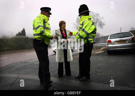 Home Secretary Jacqui Smith listens to West Mercia Police Chief Constable Paul West (left) and local policing officer PC Richard Woodhouse as she witnesses the impact of neighbourhood policing in the Redditich area. Stock Photo