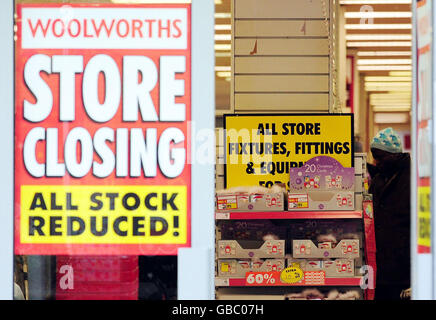 ALTERNATE CROP A sign advertising all store fixtures and fittings for sale next to the Christmas cards at the Woolworths store in Harrogate, North Yorkshire, on the final day of trading for the remaining stores. Stock Photo