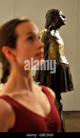 Lily Howes, ,14, a student at the Royal Ballet School, looks at the 'Petite danseuse de quatorze ans' (the Little Dancer) sculpture by Edgar Degas, in central London. The sculpture goes up for auction at Sotheby's on February 3, and is expected to sell for between 9 to 12million. Stock Photo