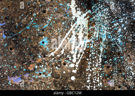 rusty iron surface covered with colorful paint splashes Stock Photo