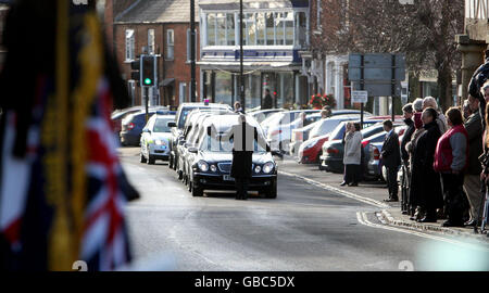 Members of the public line the streets of Wootton Bassett in Wiltshire as the bodies of three British soldiers killed in Afghanistan, Captain Tom Sawyer, 26, of the Royal Artillery, Corporal Danny Winter, 28, of the Royal Marines and Marine Travis Mackin, 22, from Plymouth, were repatriated today. Stock Photo