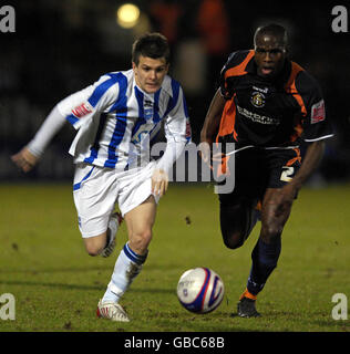 Brighton and Hove Albion's Dean Cox (left) dribbles past Luton Town's Claude Gnakpa during the Johnstone Paint Trophy match at the Withdean Stadium, Brighton. Stock Photo