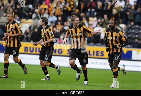 Soccer - FA Cup - Fourth Round - Hull City v Millwall - KC Stadium. Hull's Michael Turner (second right) celebrates his opening goal during the FA Cup, Fourth Round at the KC Stadium, Hull. Stock Photo